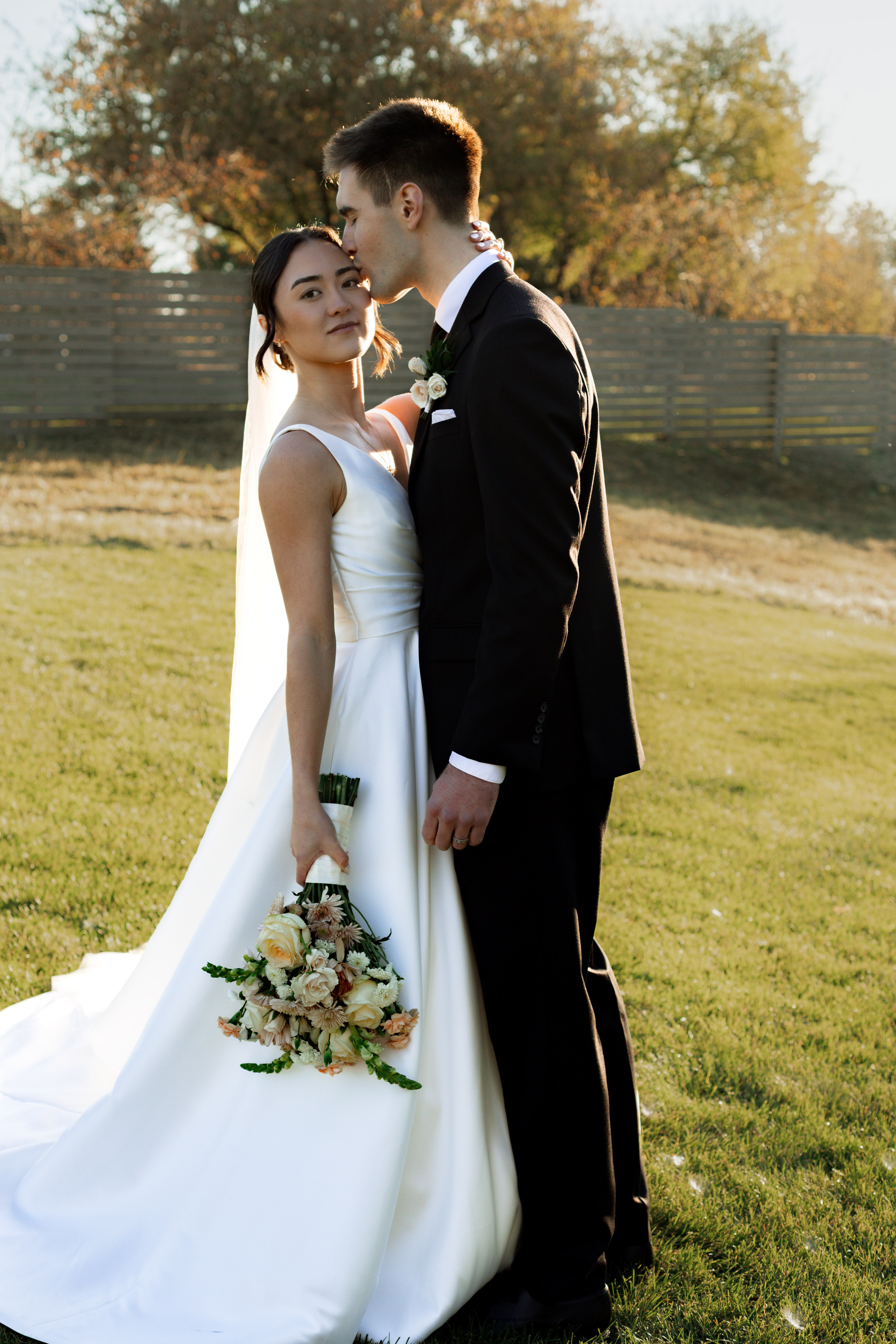 Bride in white dress with groom in natural outdoor light
